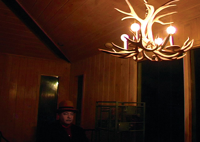 Alt Text: Scene from Caterina Verde's video, "All You Can't Eat and Other Tales of Waiting".&nbsp;&nbsp; Chandelier Question